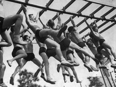 University of Louisville V-12 participants on 'monkey bars' circa 1943. From the College of Arts & Sciences V-12 photo display, University of Louisville Archives & Special Collections.