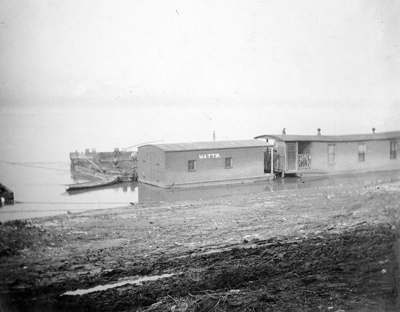 A small houseboat with a floating shed on the shore at Louisville, Kentucky