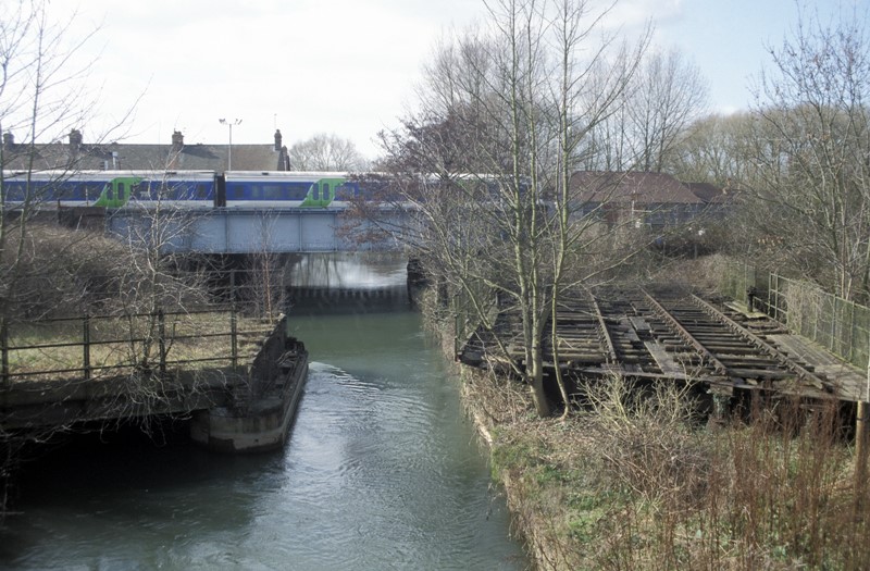A train crossing a branch of the River Thames called the Sheepwash Channel which connects it with the Oxford Canal